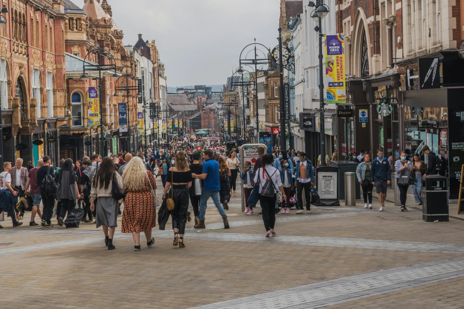 Shoppers walking down a busy pedestrianised high street